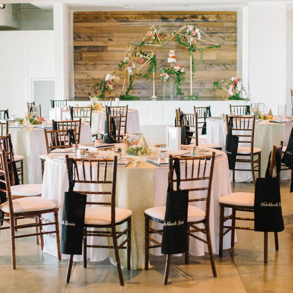 The Colony House Loft filled with draped, white tables and chairs ready for an event