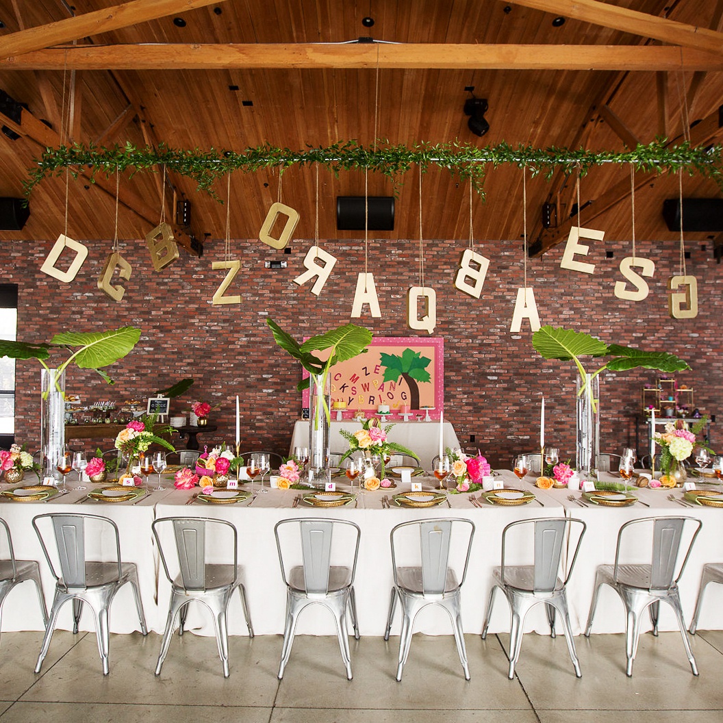 An event with a long, decorate table in the center of The Colony House Great Room