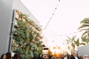 The Colony House Patio filled with people during an event at sunset