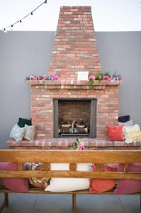 A brick fireplace located outside on The Colony House Patio