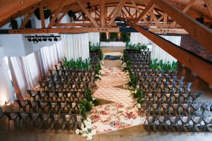 The Colony House Great Room prepped with chairs and floral decorations for a ceremony